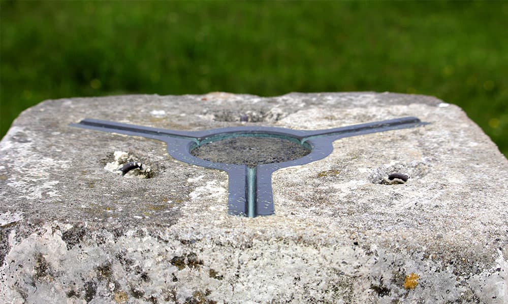 Top of a UK trig pillar showing the brass theodolite mounting plate
